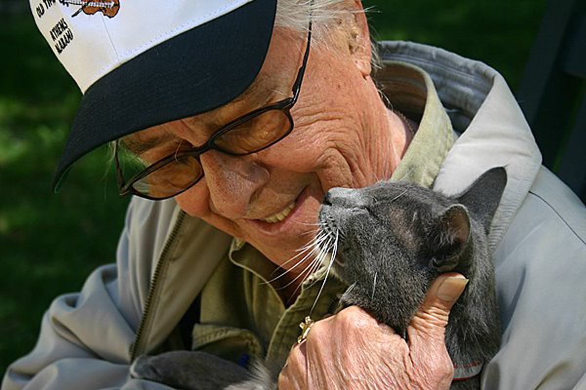 senior man holding cat